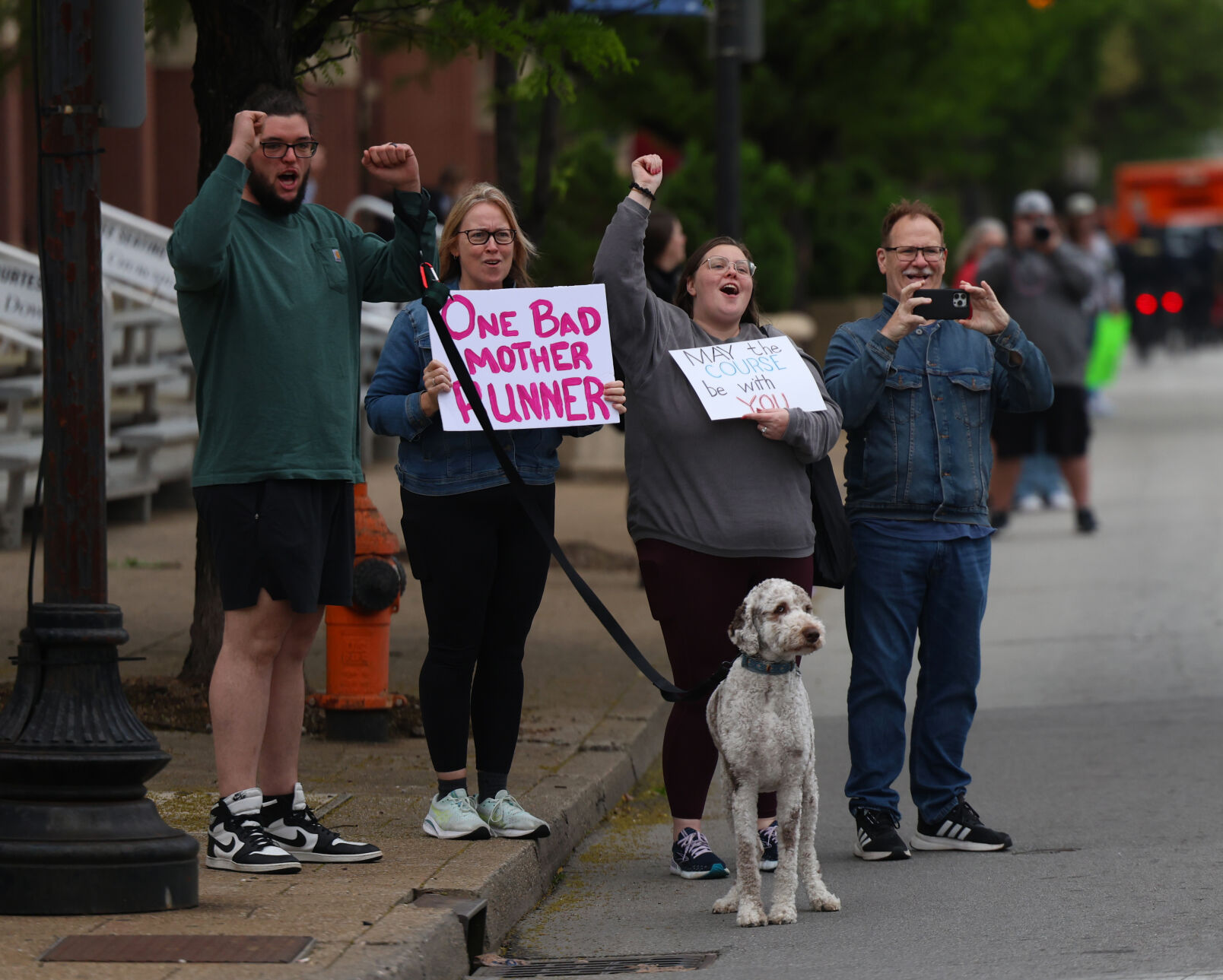 Supporters hold signs on Broadway.JPG